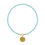 aqua beaded necklace with a gold pendant on a white background