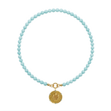 aqua beaded necklace with a gold pendant on a white background