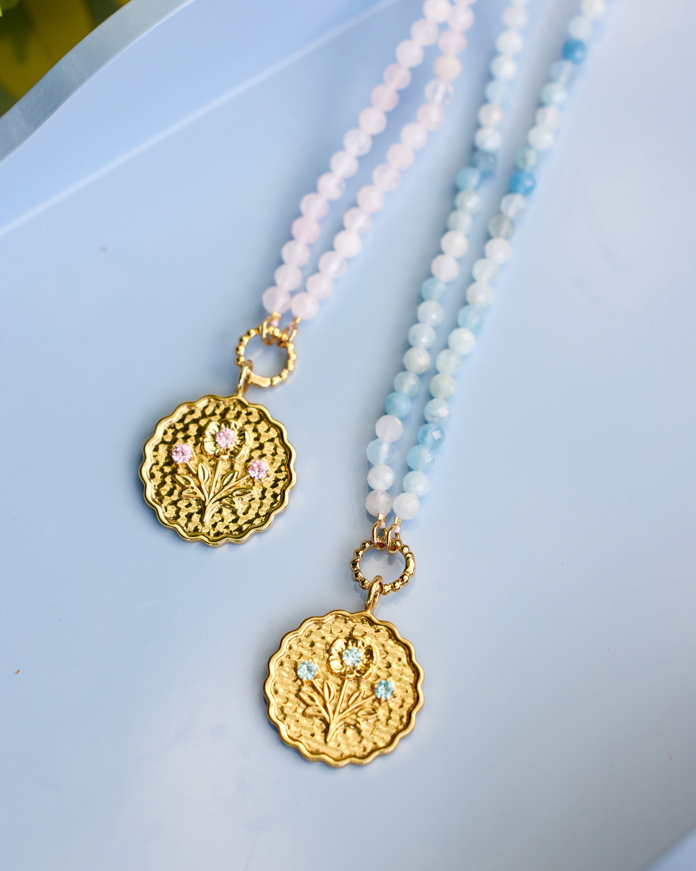 pink and blue beaded necklaces with gold pendant coins