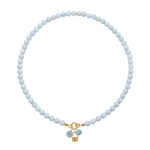 Necklace with light blue beads and a gold charm on a white background