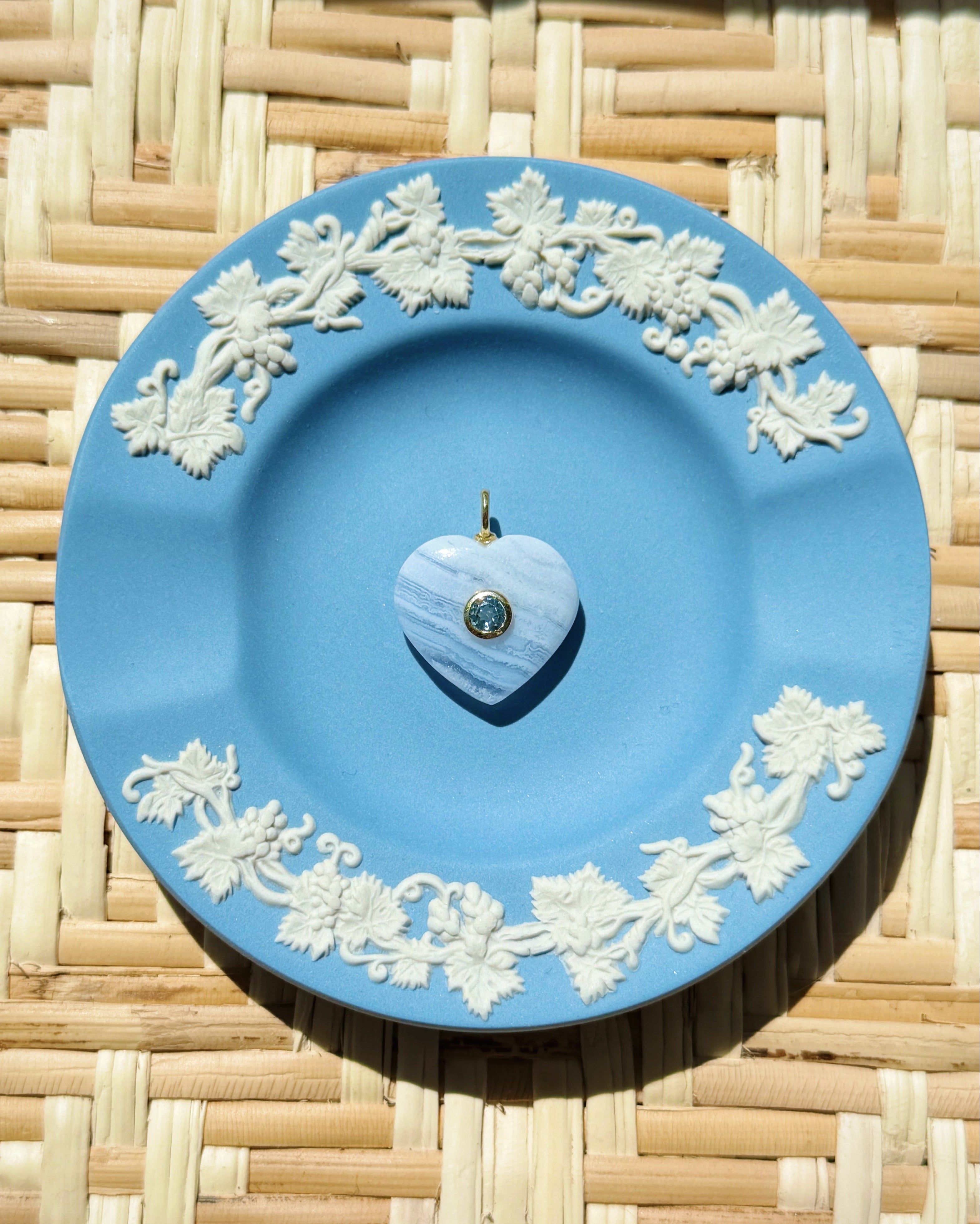 blue lace agate heart charm on a blue plate