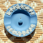 blue opal shell charm on a blue plate