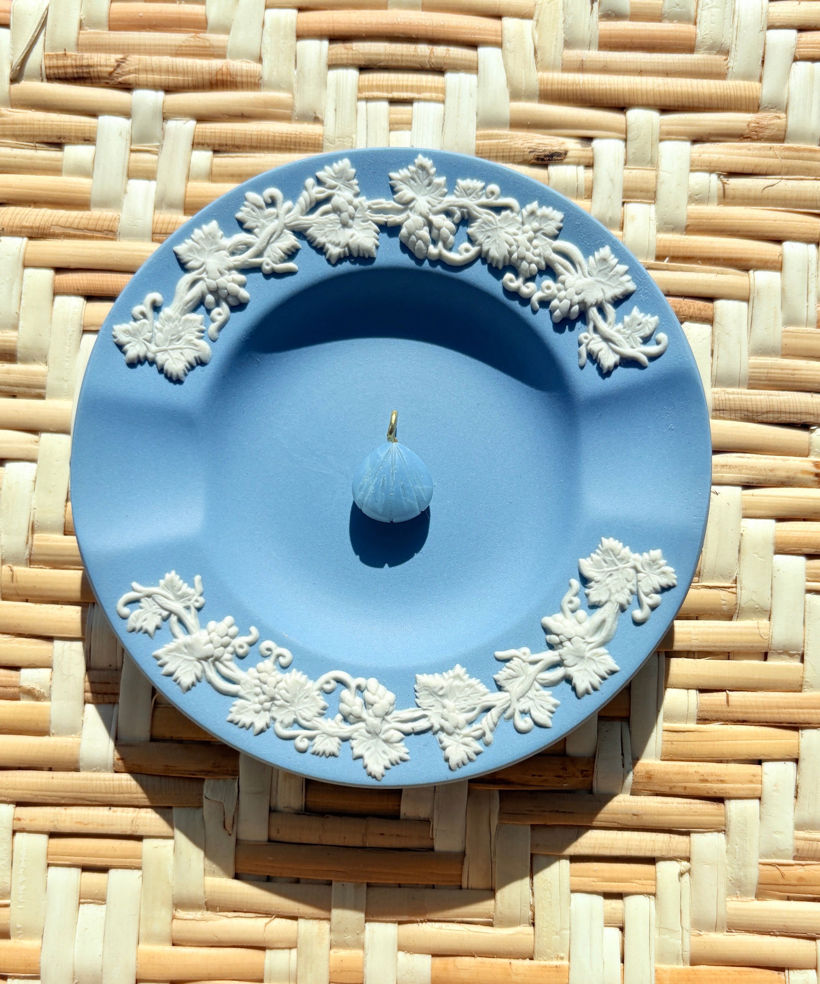 blue opal shell charm on a blue plate