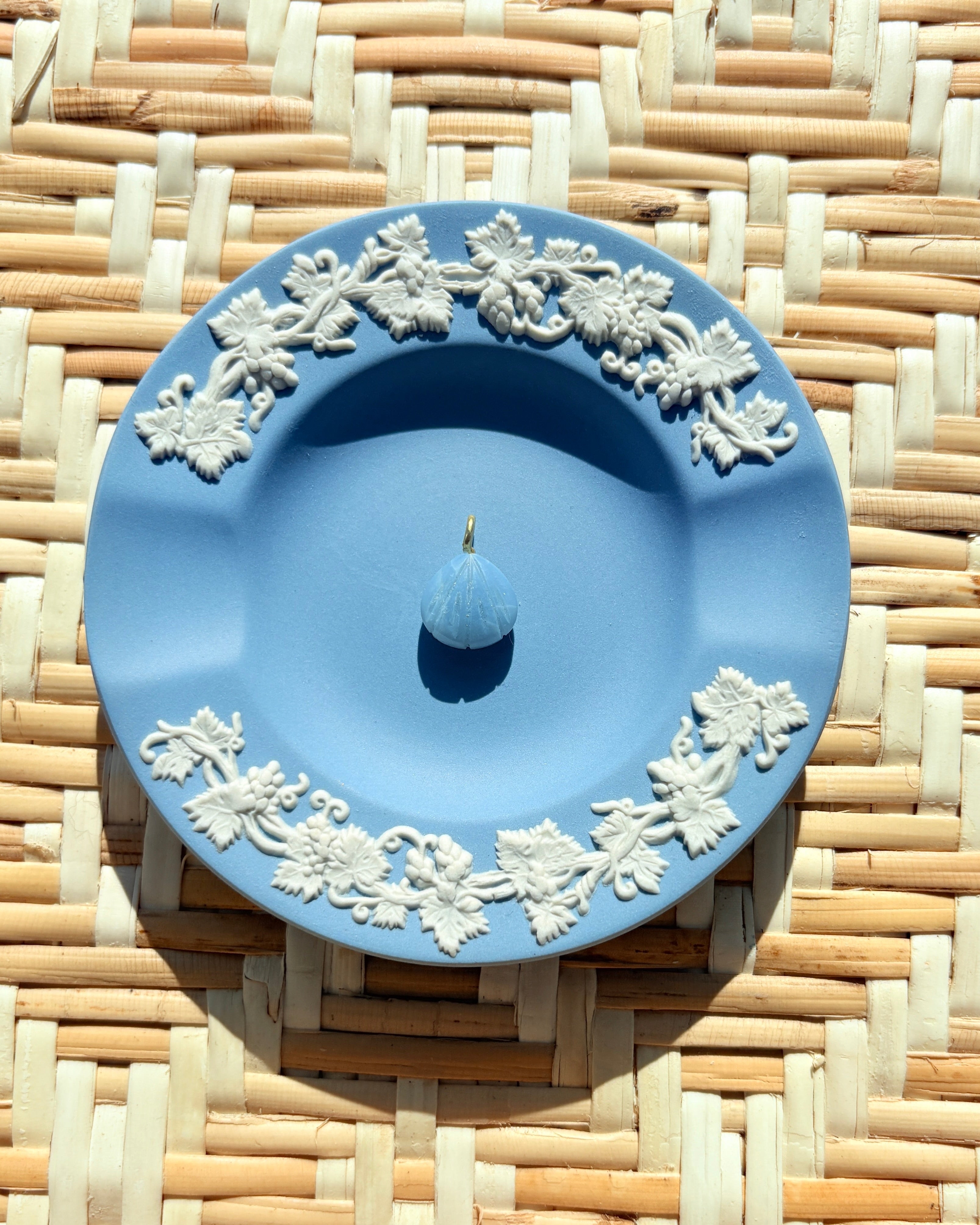 blue opal shell charm on a blue plate