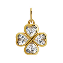 Golden clover charm with clear gemstones on a white background