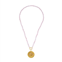 Necklace with pink beads and a gold pendant on a white background
