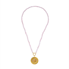 Necklace with pink beads and a gold pendant on a white background