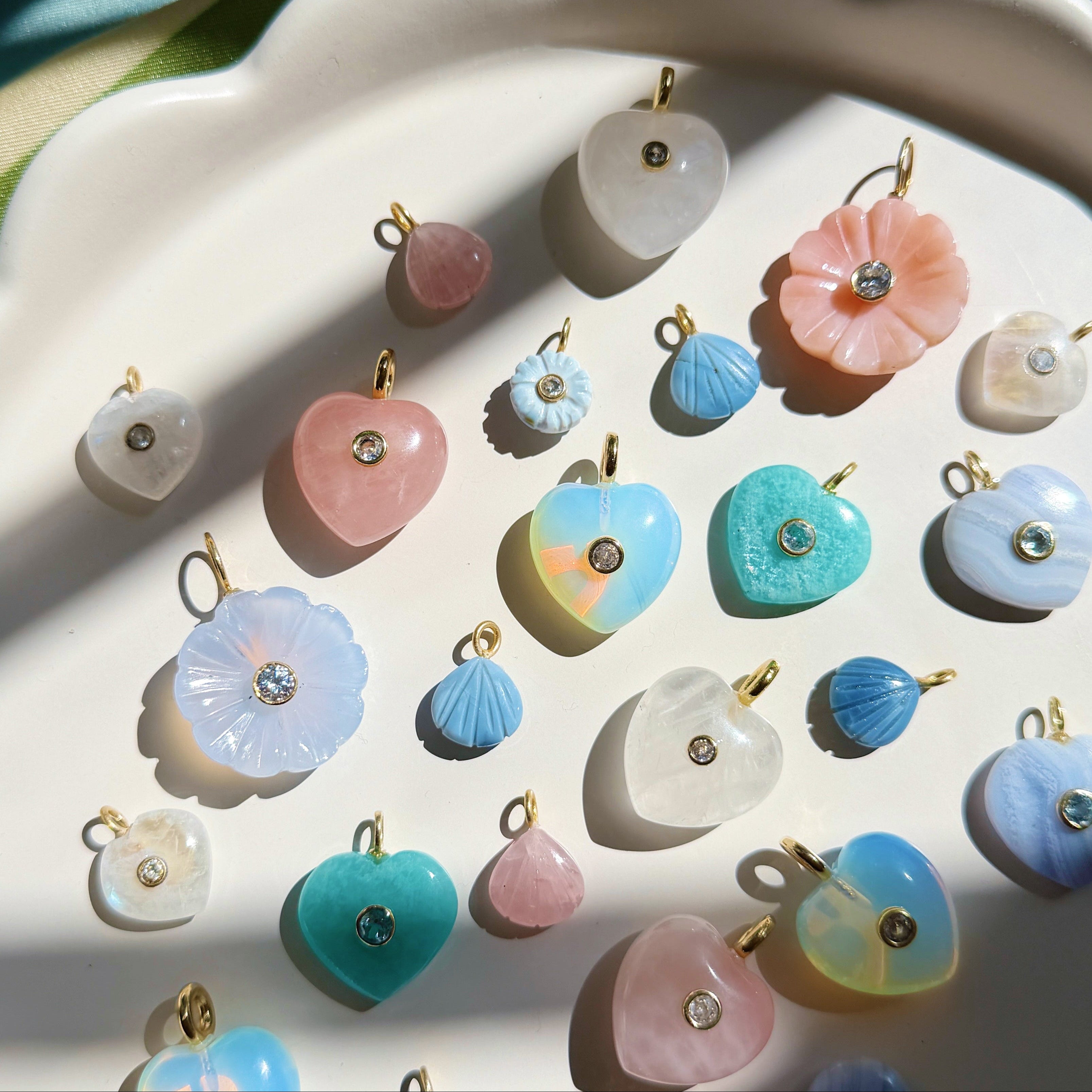 colorful stone charms on a white scalloped plate