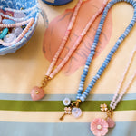 three beaded necklaces on a silk scarf