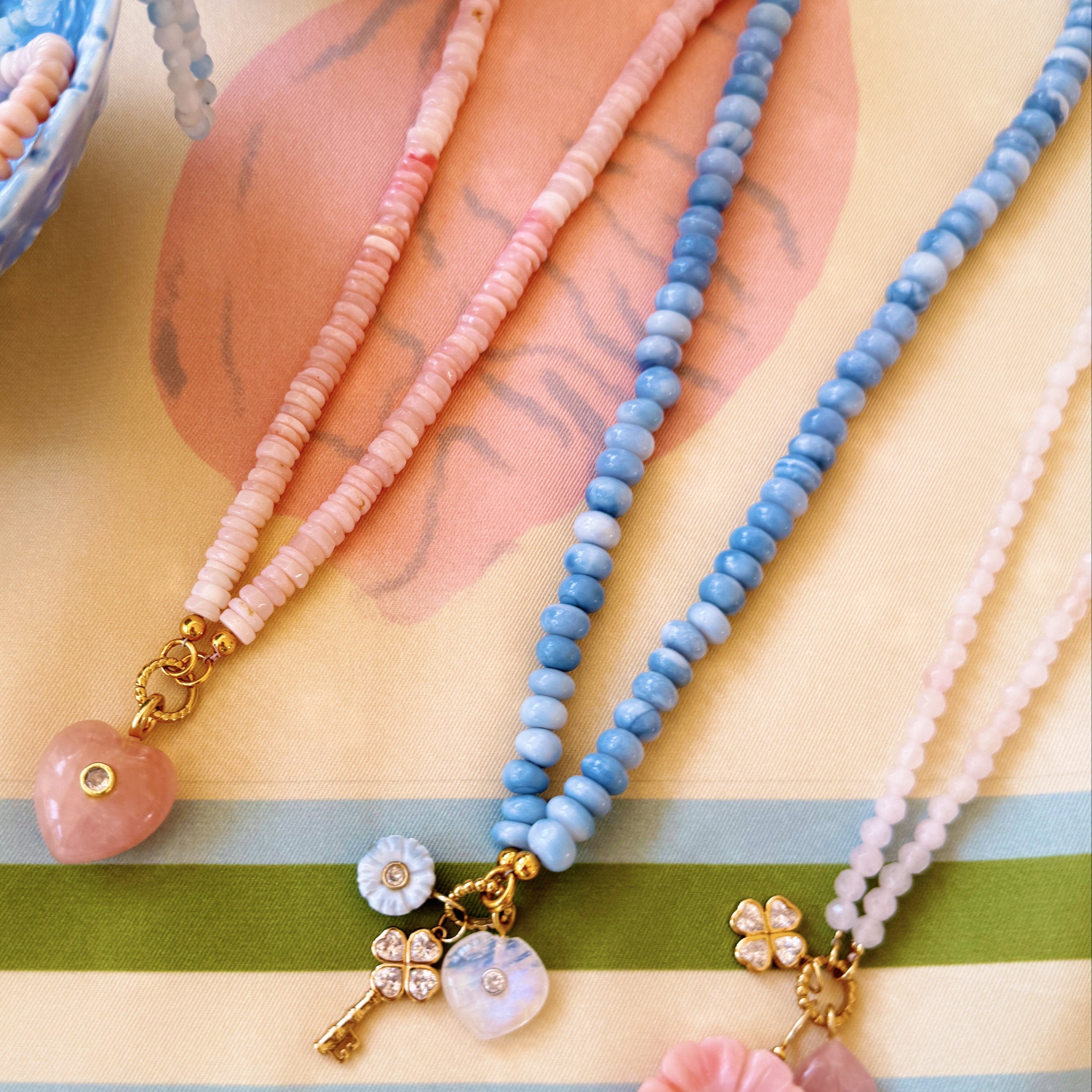 three beaded necklaces on a silk scarf