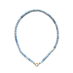 Necklace with light blue beads on a white background