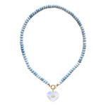 Necklace with light blue beads and a heart-shaped pendant on a white background