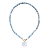 Necklace with light blue beads and a heart-shaped pendant on a white background