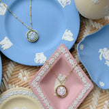 blue and pink cameo necklaces on blue and pink plates