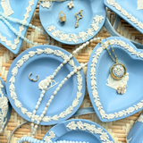 Blue decorative plates with jewelry on a woven surface