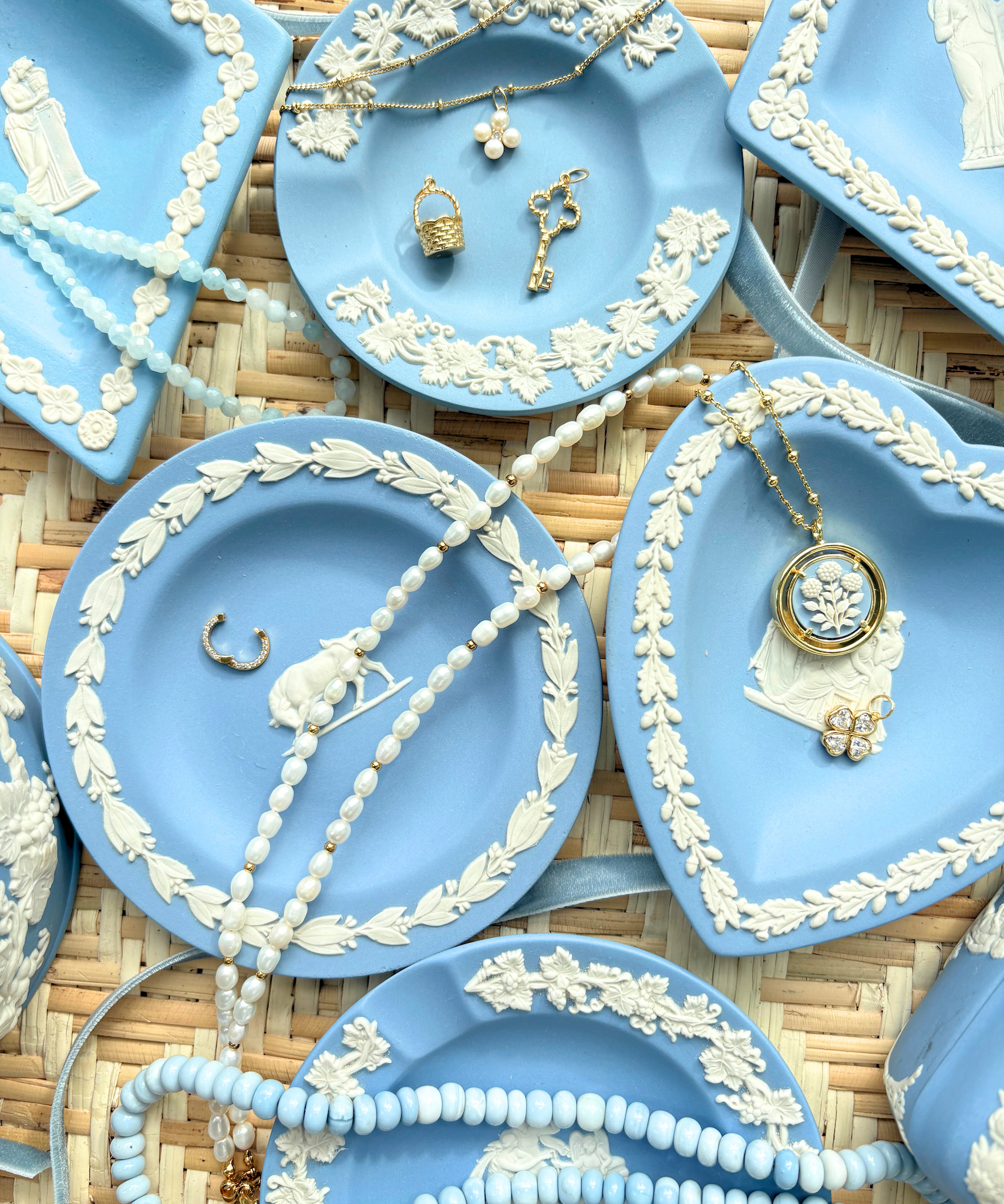 Blue decorative plates with jewelry on a woven surface