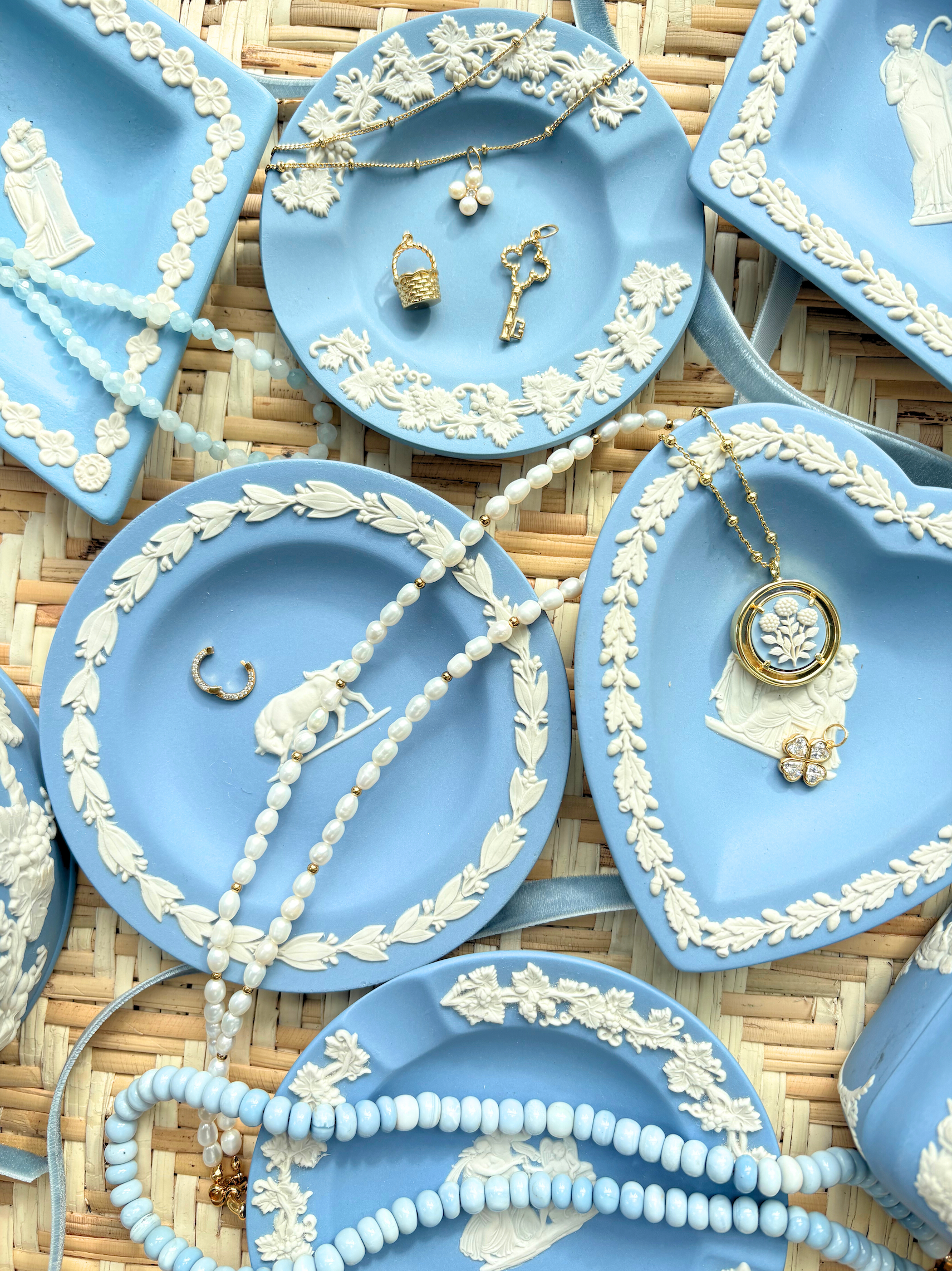 Blue decorative plates with jewelry on a woven surface