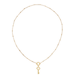 golden necklace with station beads a charm keeper and a key charm
