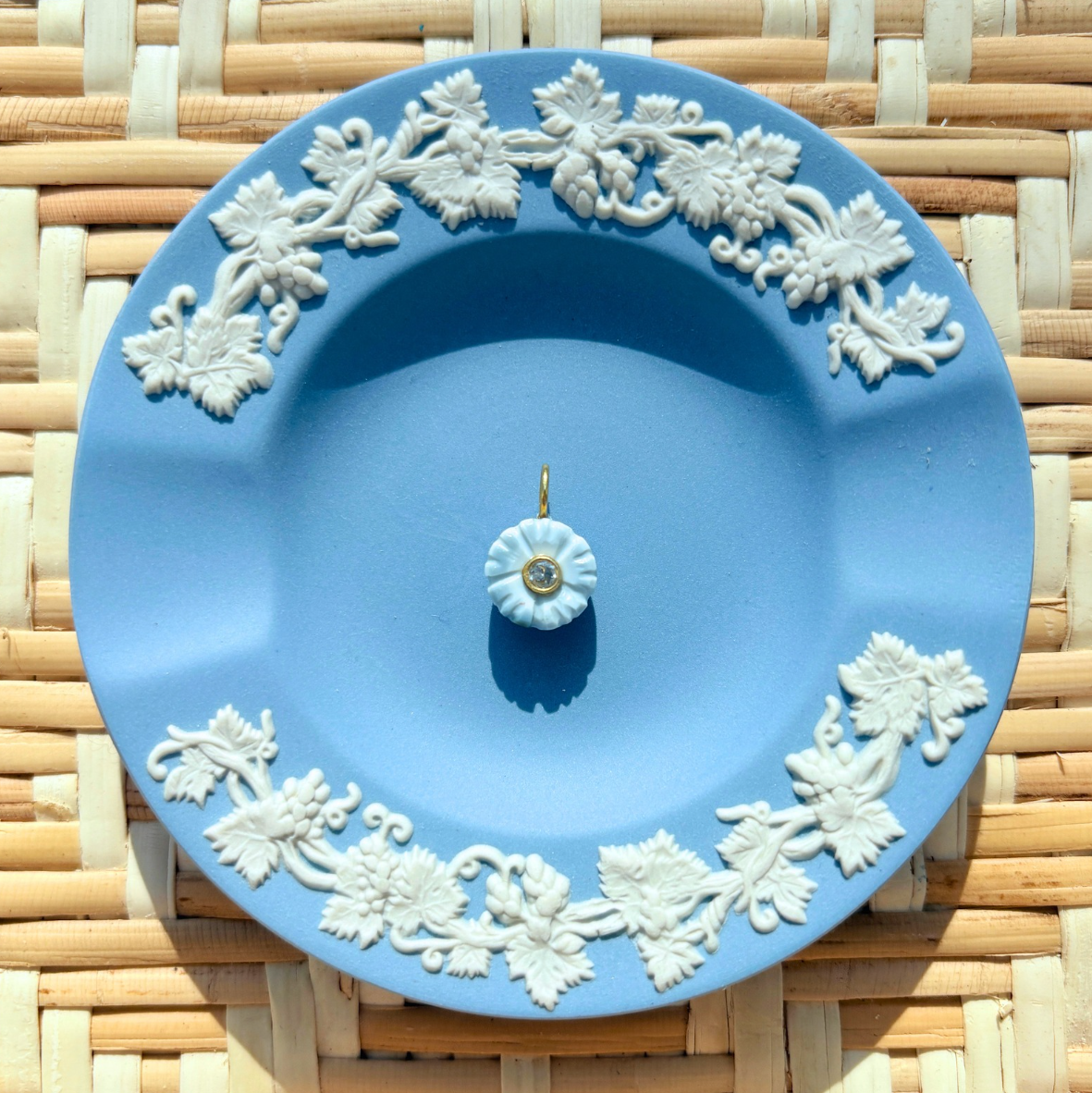 blue floral charm on a blue plate