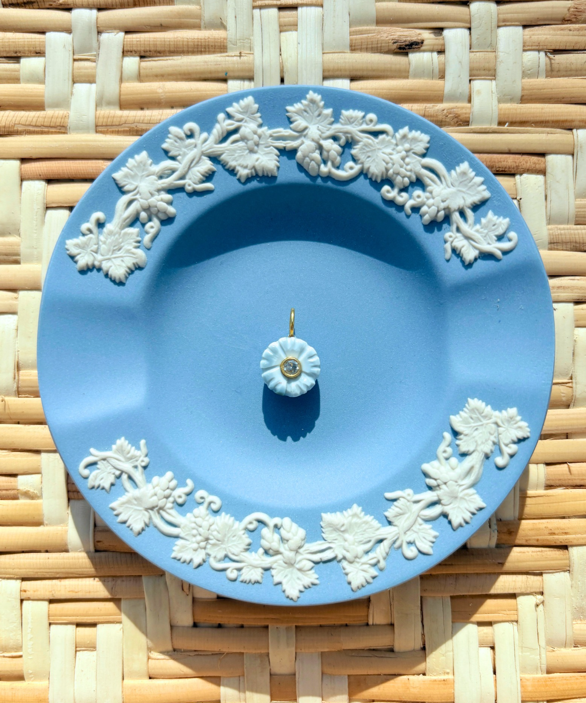 blue floral charm on a blue plate