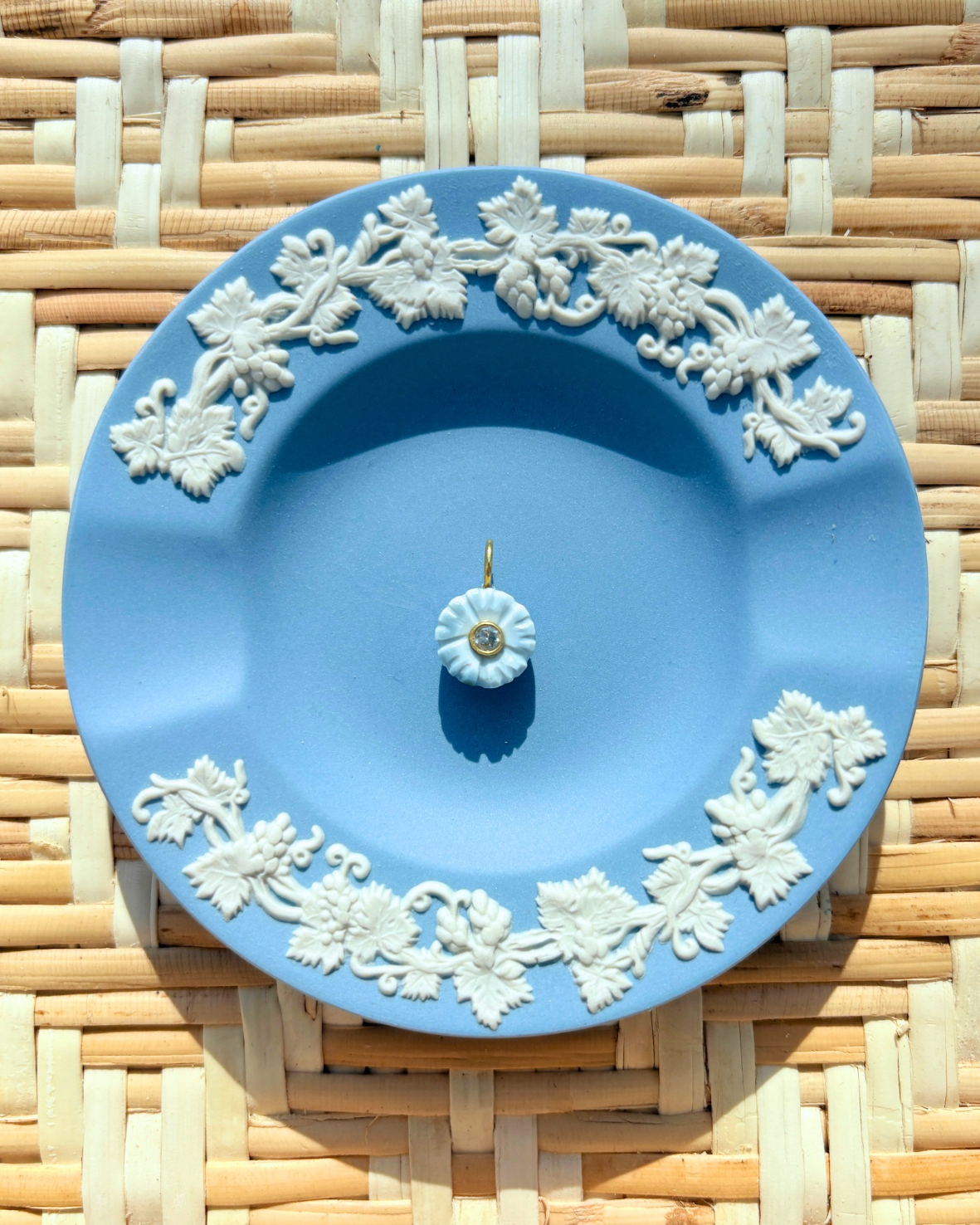 blue floral charm on a blue plate