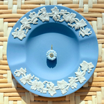 blue floral charm on a blue plate