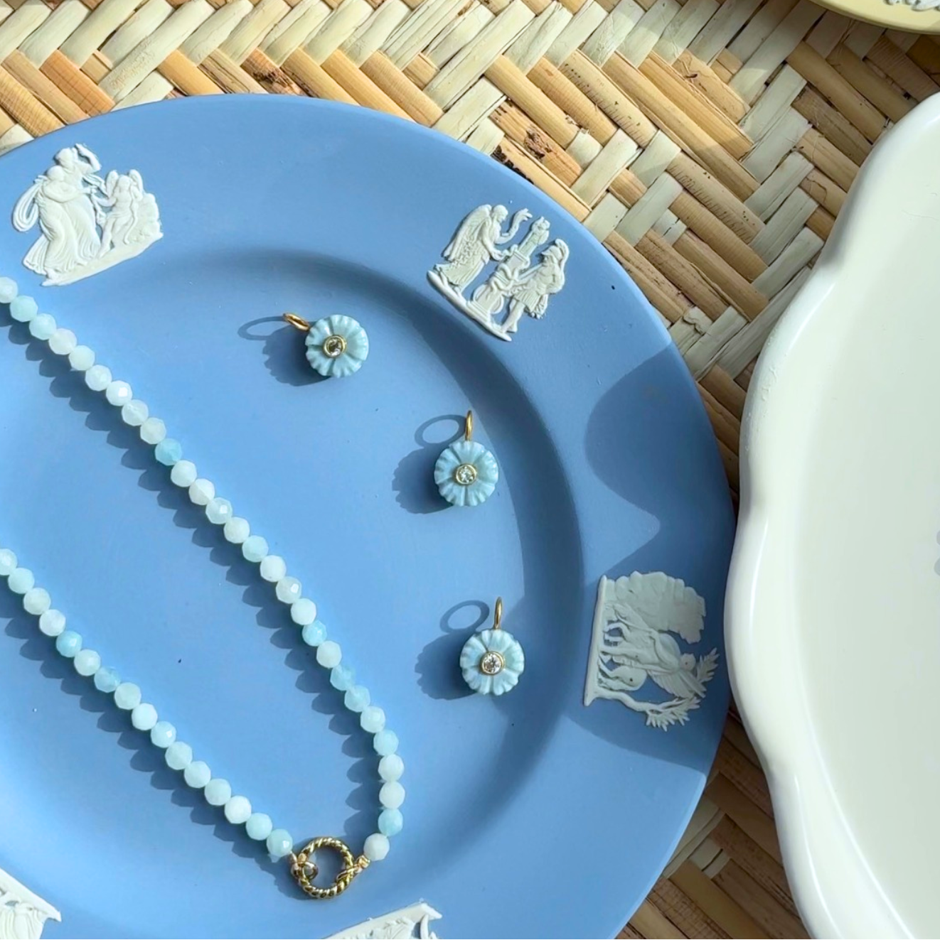 small blue floral bud charms styled on a blue plate