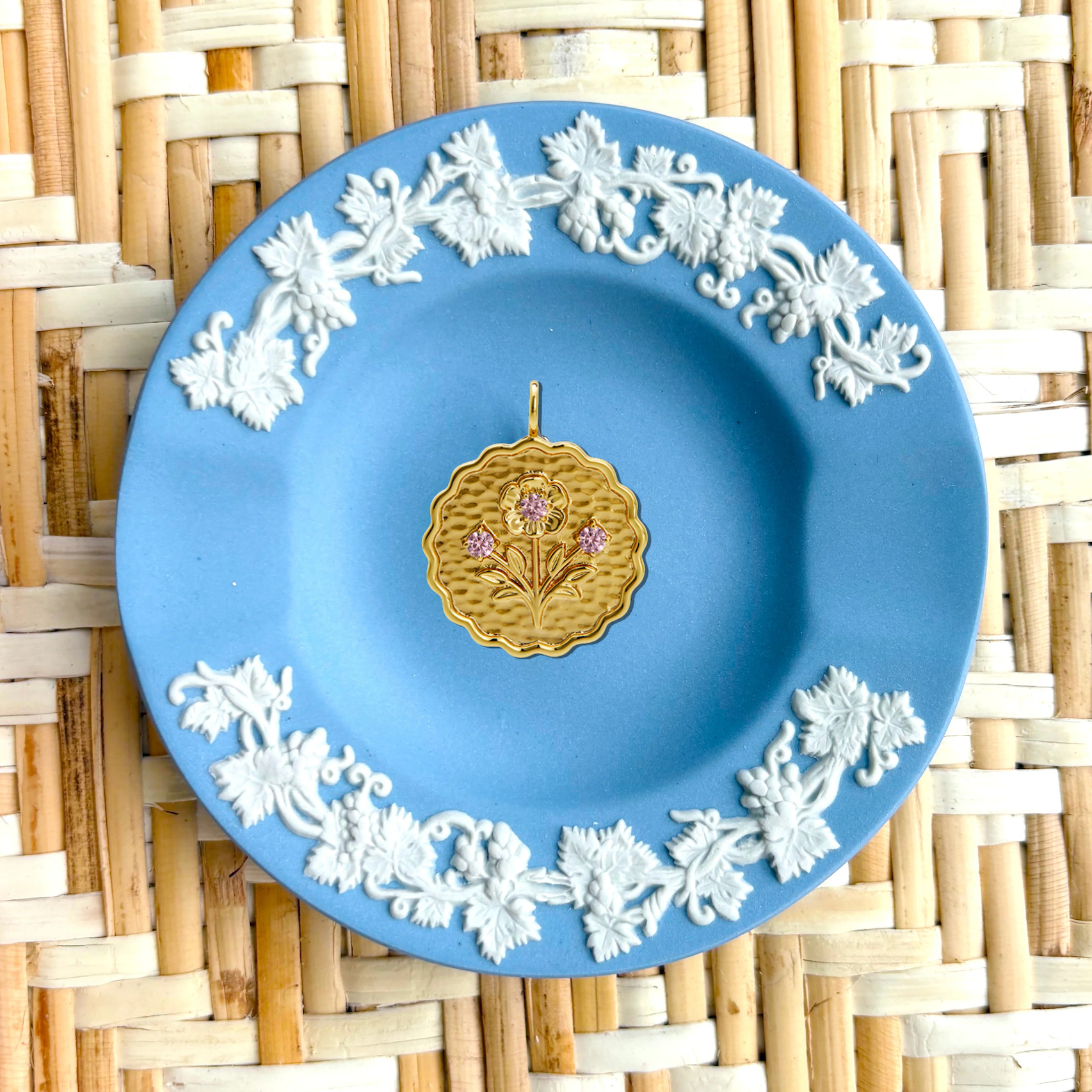 Decorative plate with floral patterns on a woven mat background