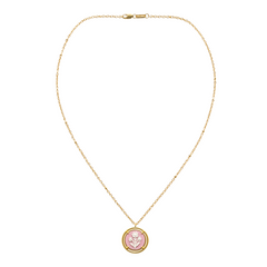 pink cameo pendant on a gold chain on white background