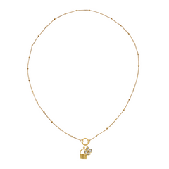 Golden necklace with a basket charm and clover charm on a white background