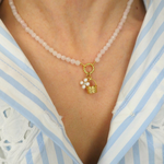 rose quartz necklace with a basket charm and pearl flower charm